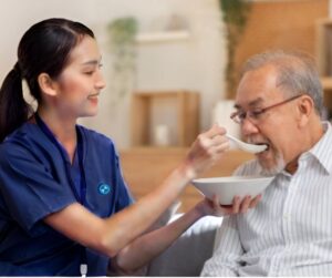 caregiver feeding elderly