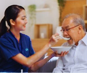 caregiver feeding elderly